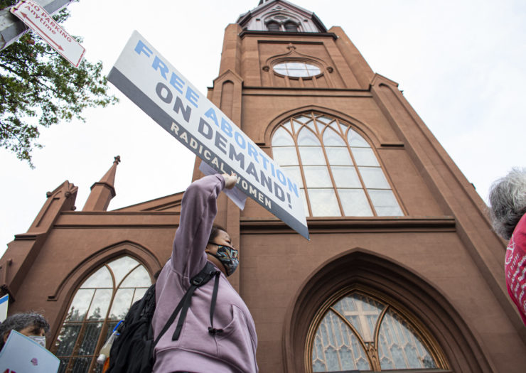 Photo of protesters outside NYC Catholic church holding sign that reads Free Abortion on Demand!
