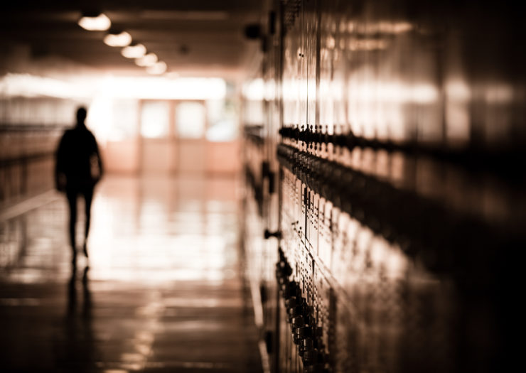 Photo of student's silhouette in a school hallway