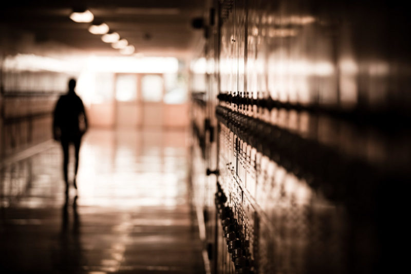 Photo of student's silhouette in a school hallway
