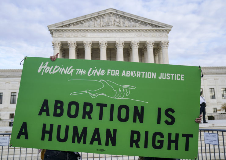 Photo of green sign that reads Abortion is a human right