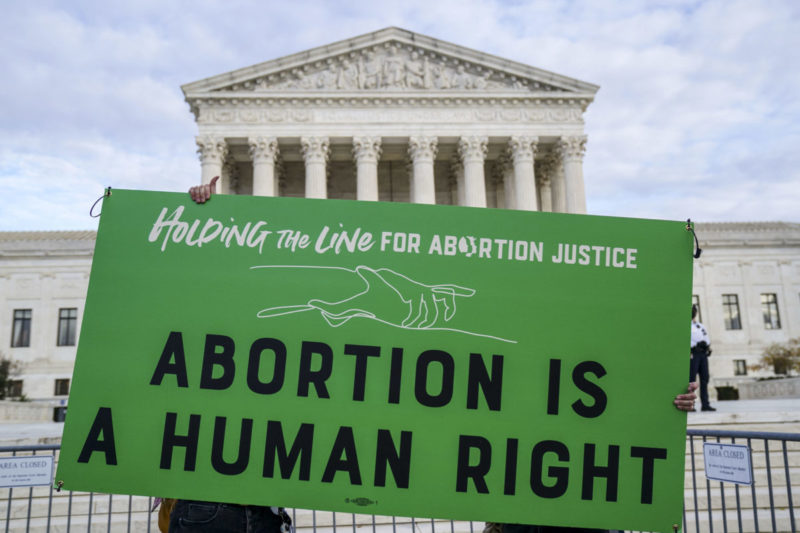 Photo of green sign that reads Abortion is a human right