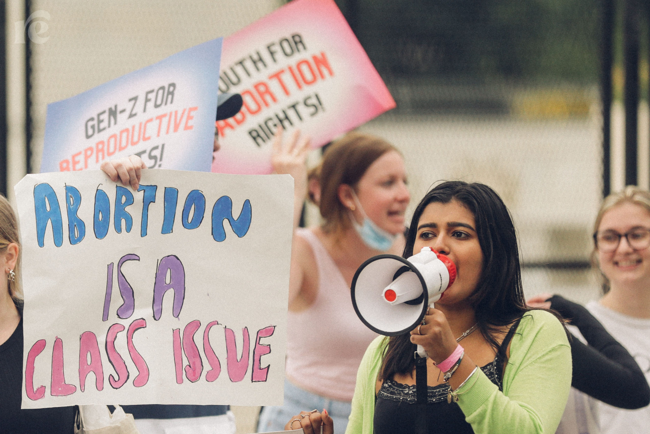 Abortion rights photo of a person holding a sign reading Abortion Is a Class Issue