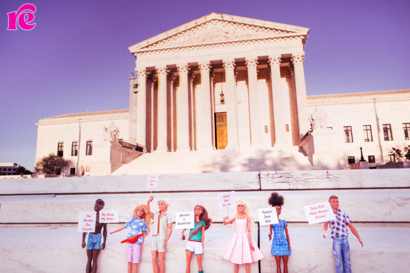 Barbies holding abortion signs in front of the Supreme Court