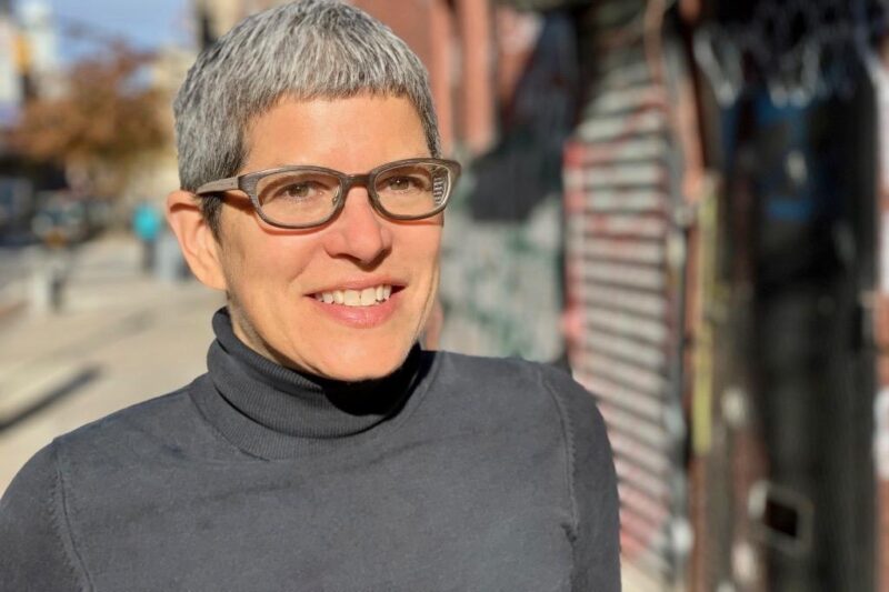 Susan Buttenwieser has short salt and pepper hair and wears glasses