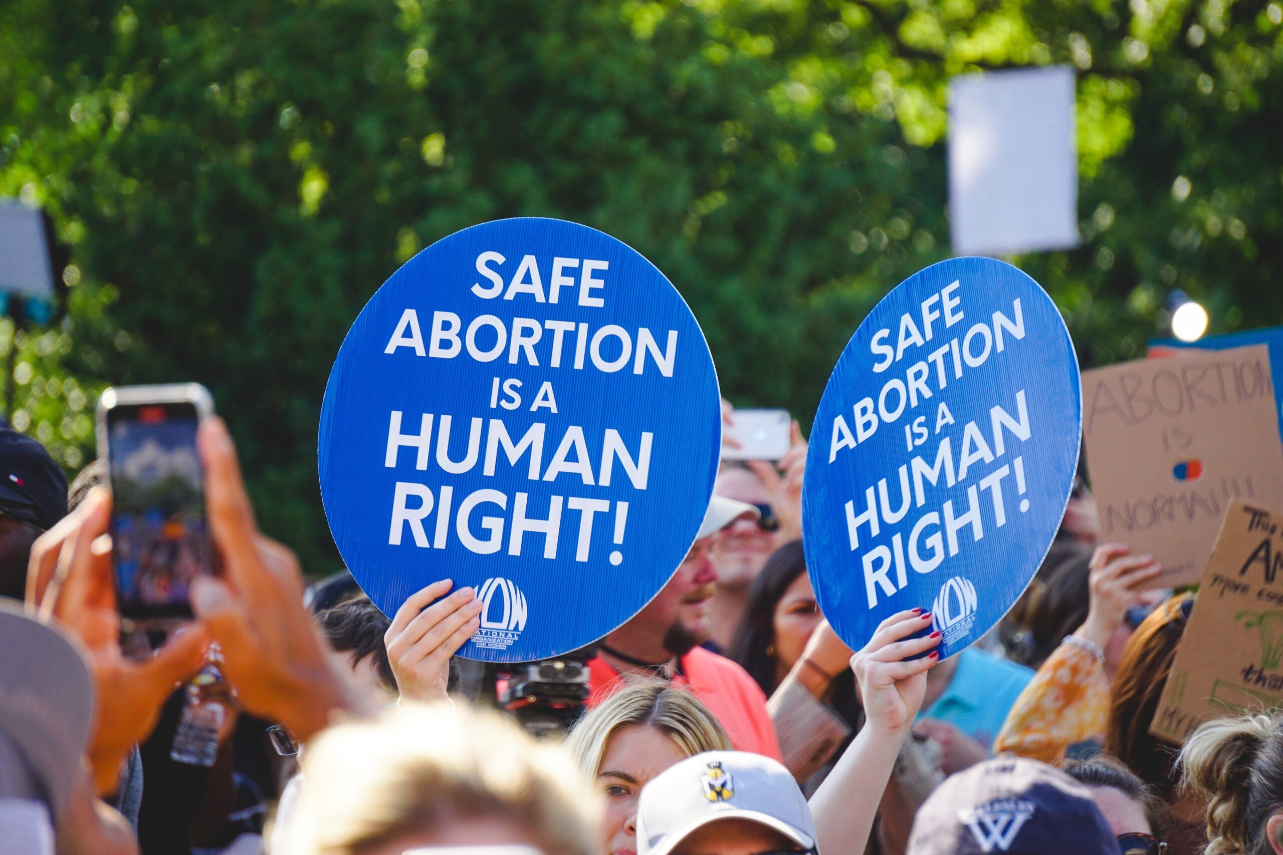 Protesters hold signs reading "Safe abortion is a human right!"