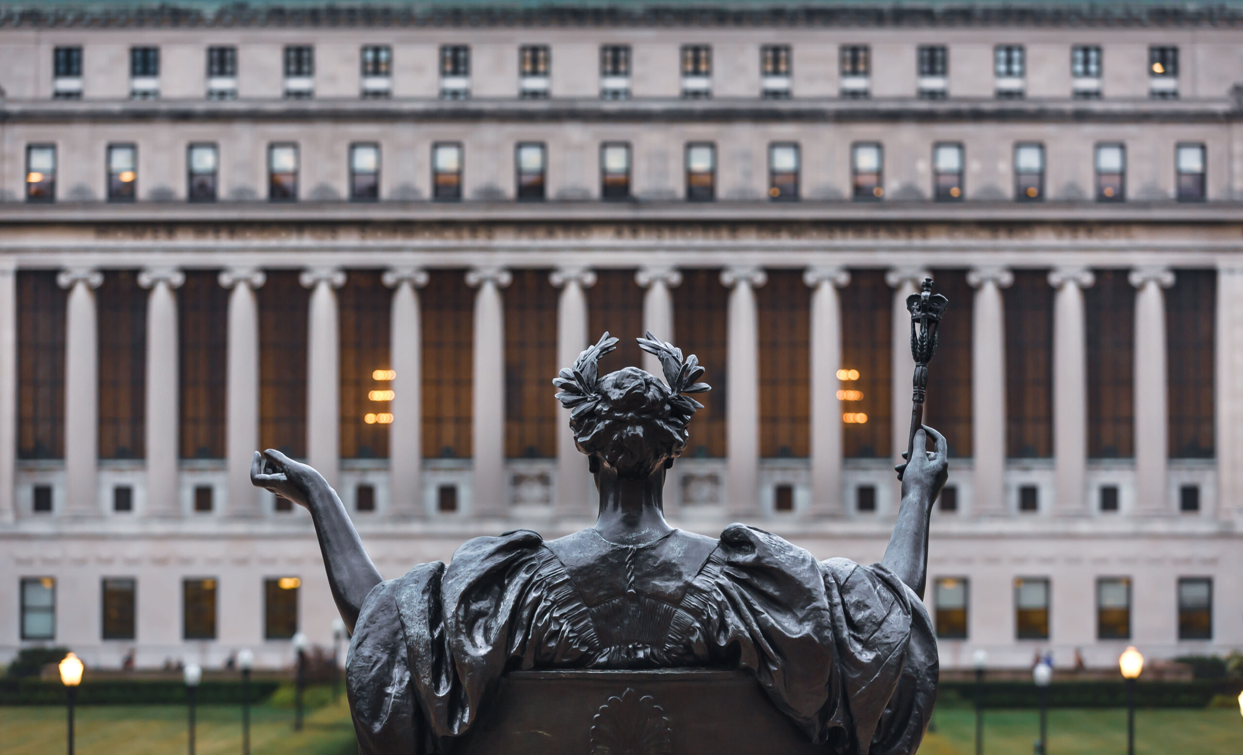 Back of a statue facing a Columbia University building