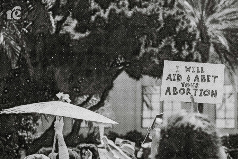 A sign at a protest reading,