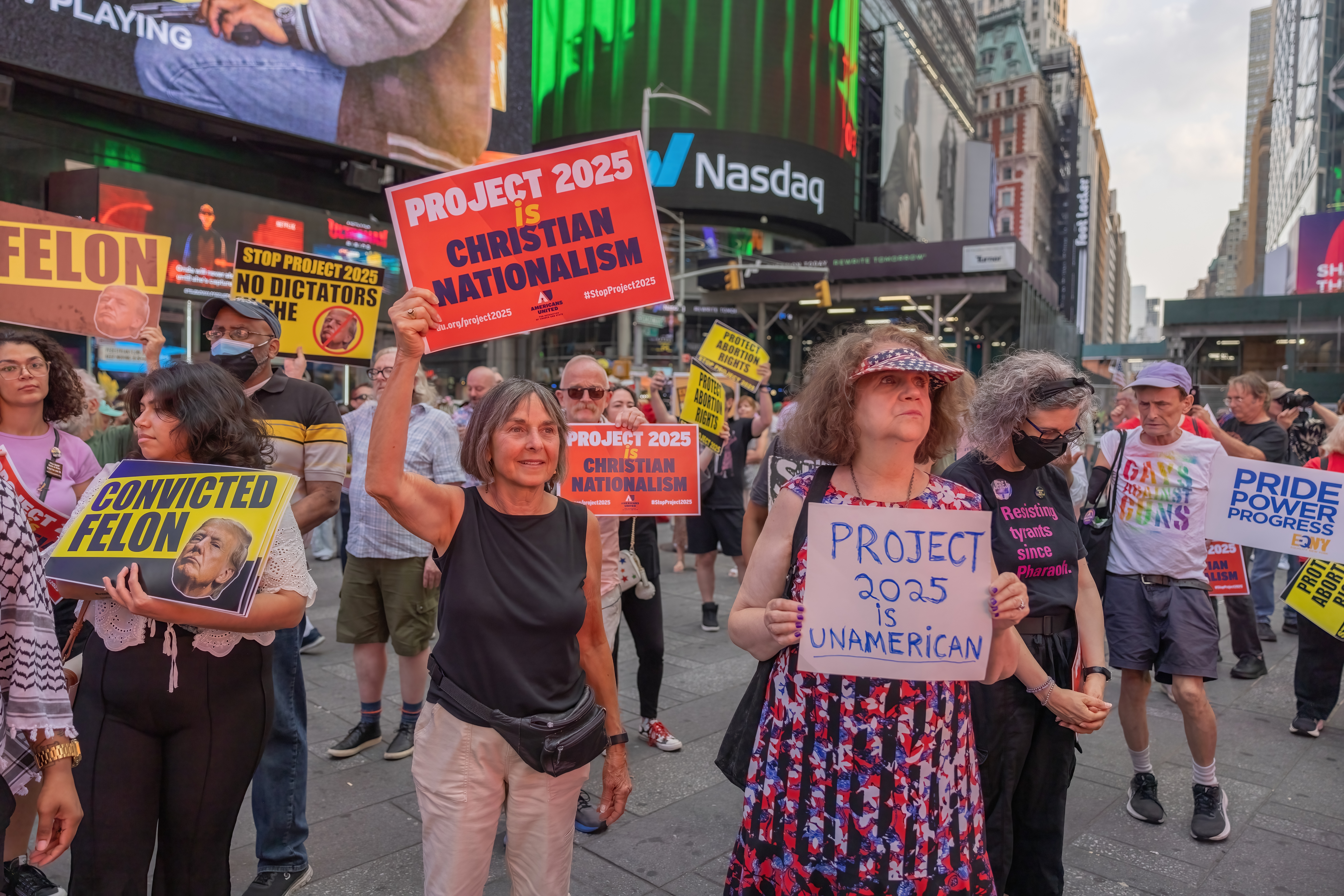 A protest in Times Square. Protesters hold signs reading "Project 2025 is Christian nationalism," "Project 2025 is un-American," and "Pride Power Progress."