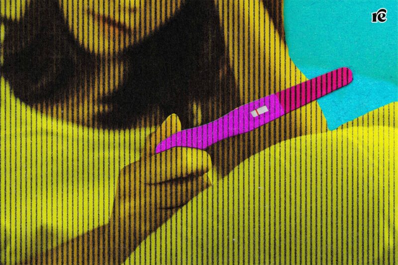 Young woman holding pregnancy test showing a negative result, in reference to impending Trump IVF policy recommendations
